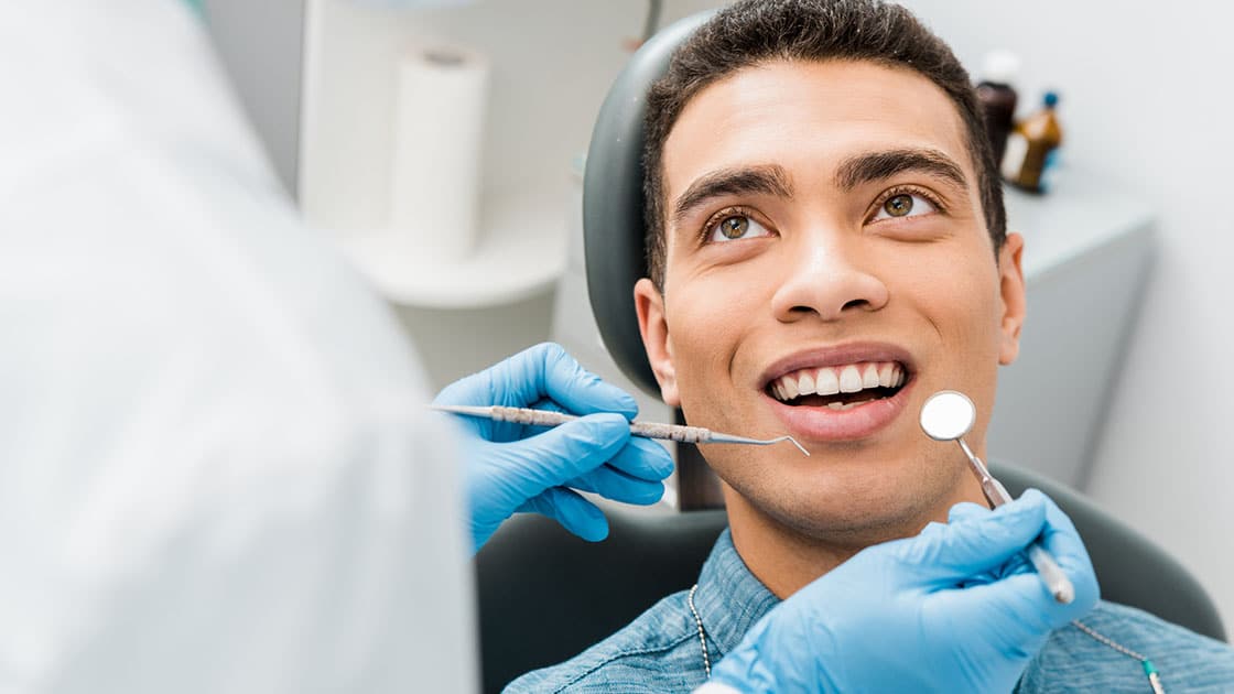 Young man smiling in dentist chair